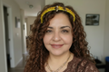 Model wearing yellow beaded headband with bee charms